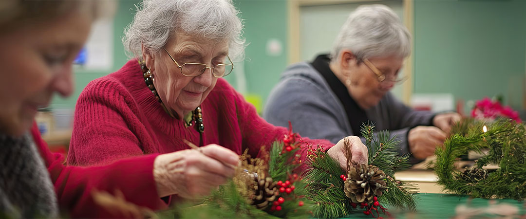 Seniors doing crafts together at a table.